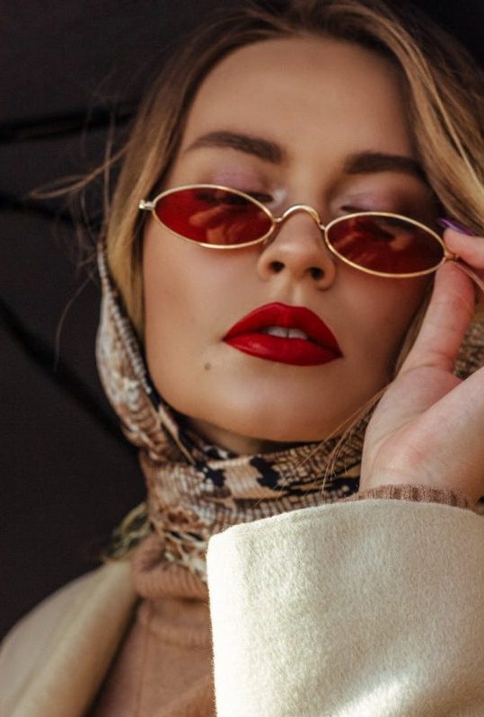 Blonde girl iin headscarf, red glasses and red lipstick
