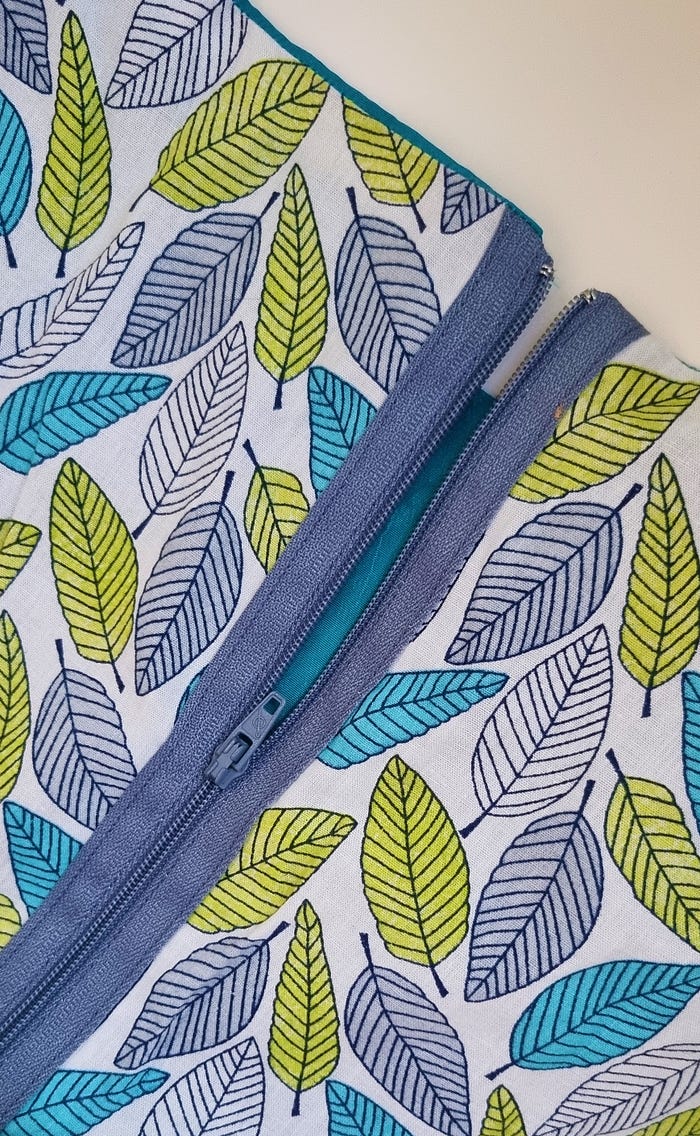 Close up of co-ordinated colour zip on outside of garment