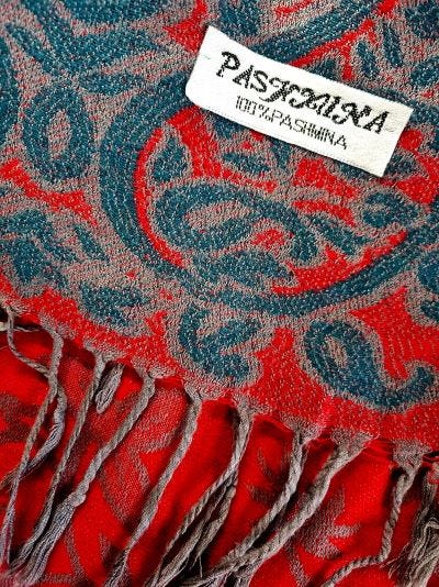 Red and grey Pashmina showing 100% Pashmina label